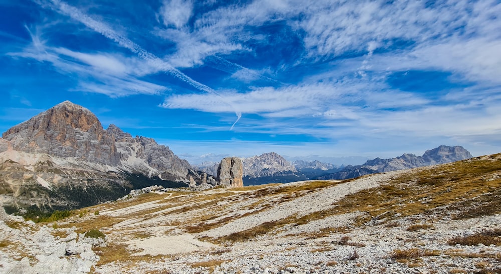 a view of a mountain range from the top of a hill