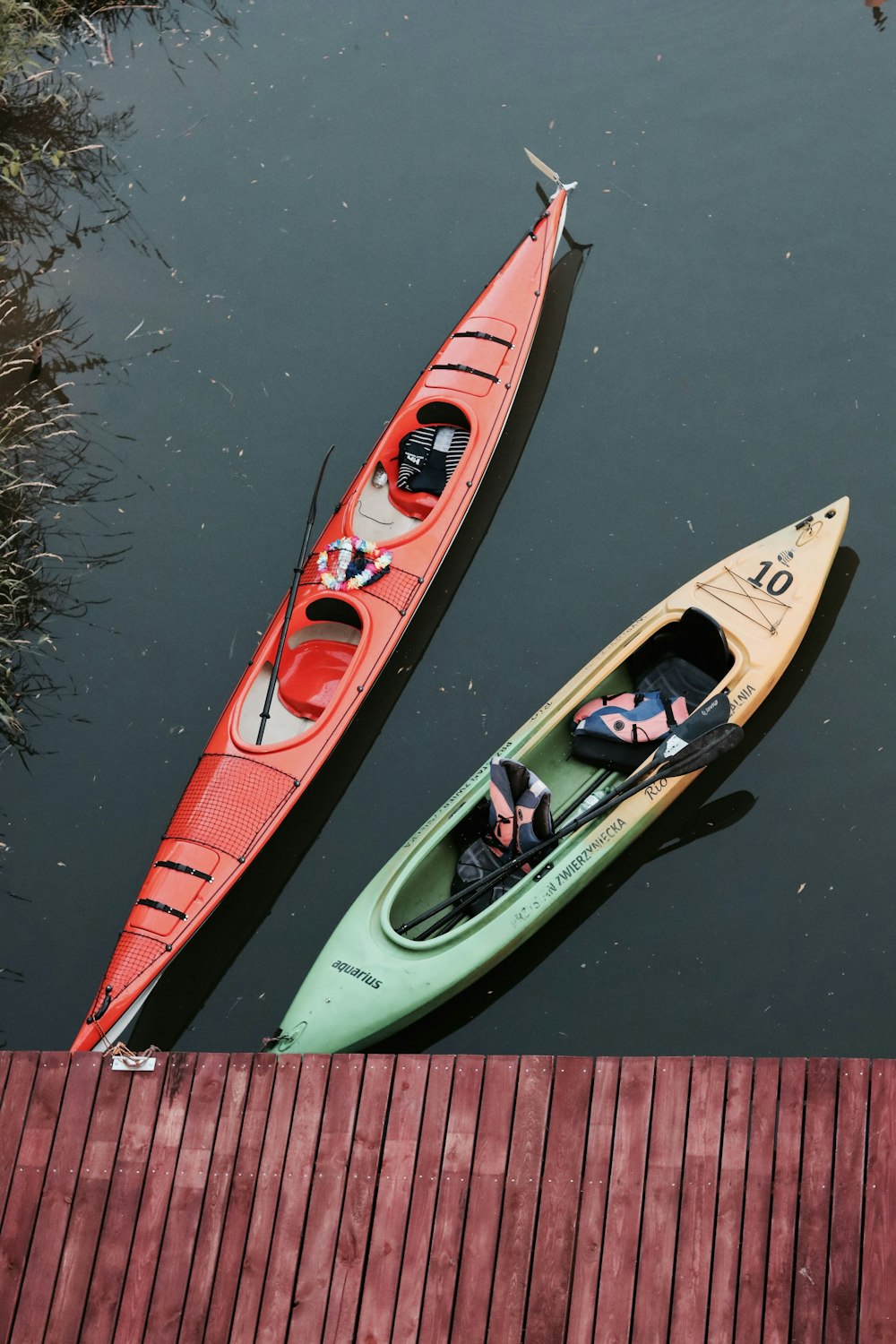 a couple of kayaks sitting on top of a body of water