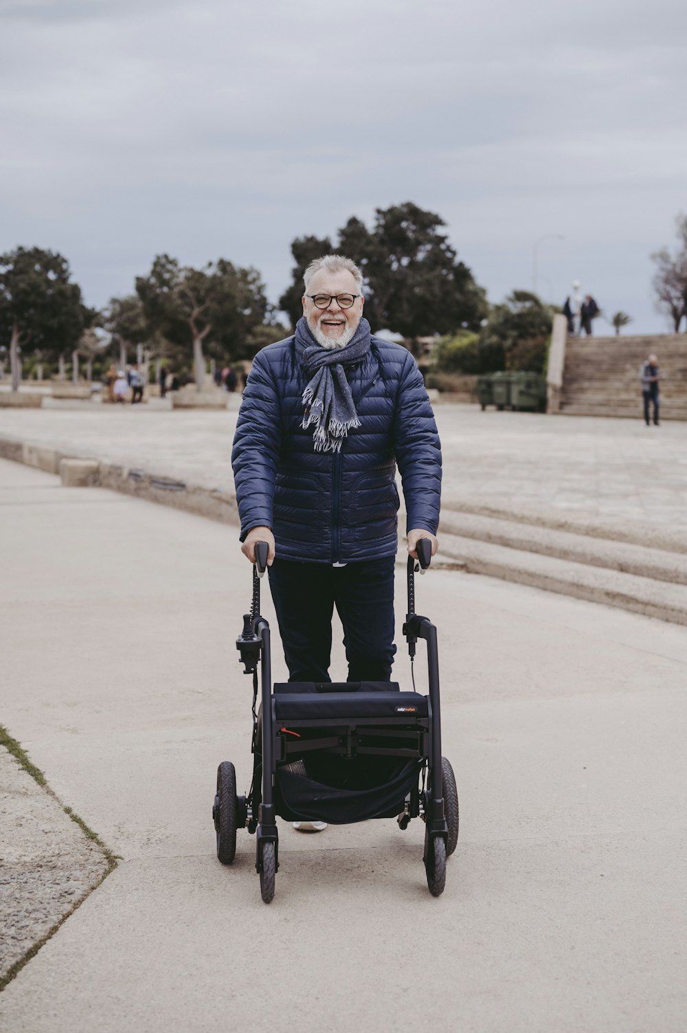 a man in a blue jacket is pushing a stroller