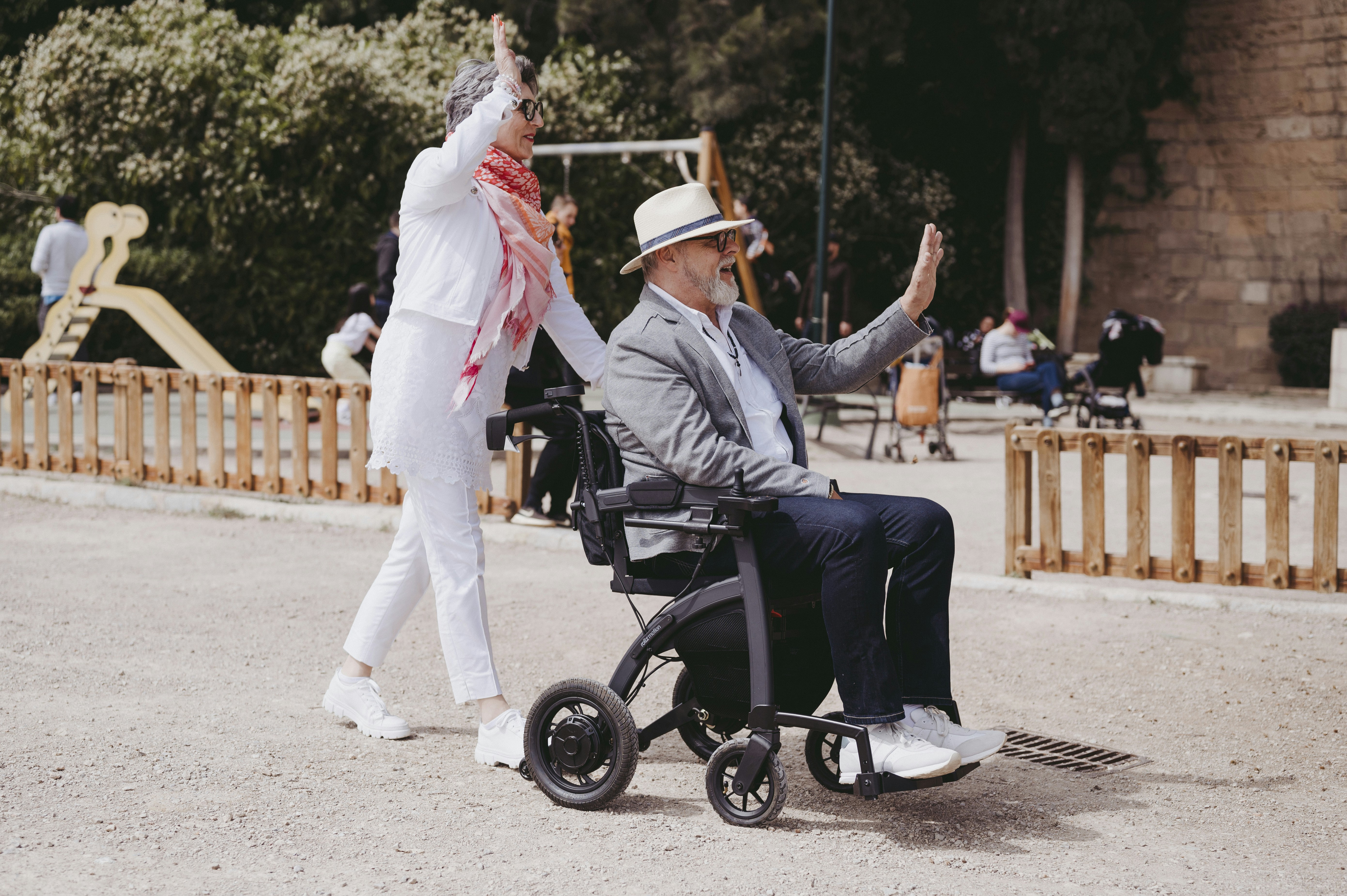 a man in a wheel chair and a woman in a white outfit