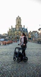 a woman standing next to an electric scooter