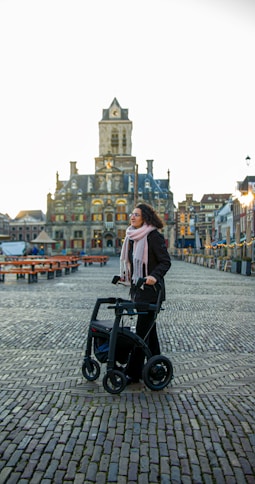 a woman standing next to an electric scooter