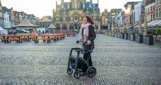 a woman standing next to a black scooter