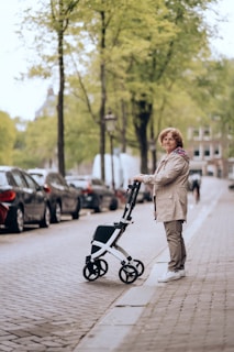 a woman standing next to a stroller on a sidewalk