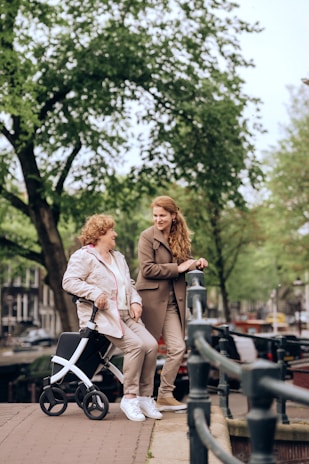a woman pushing a stroller next to another woman