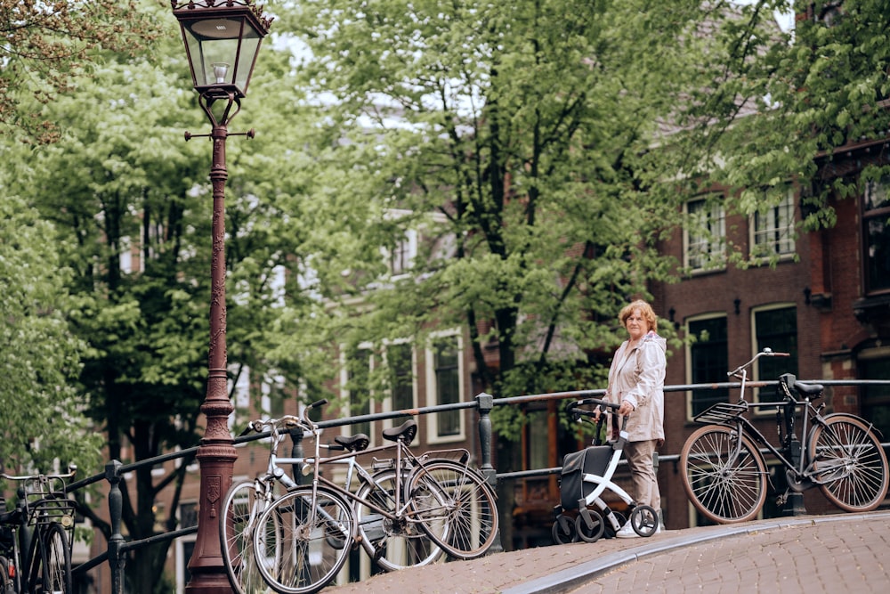 a woman standing next to a row of bikes