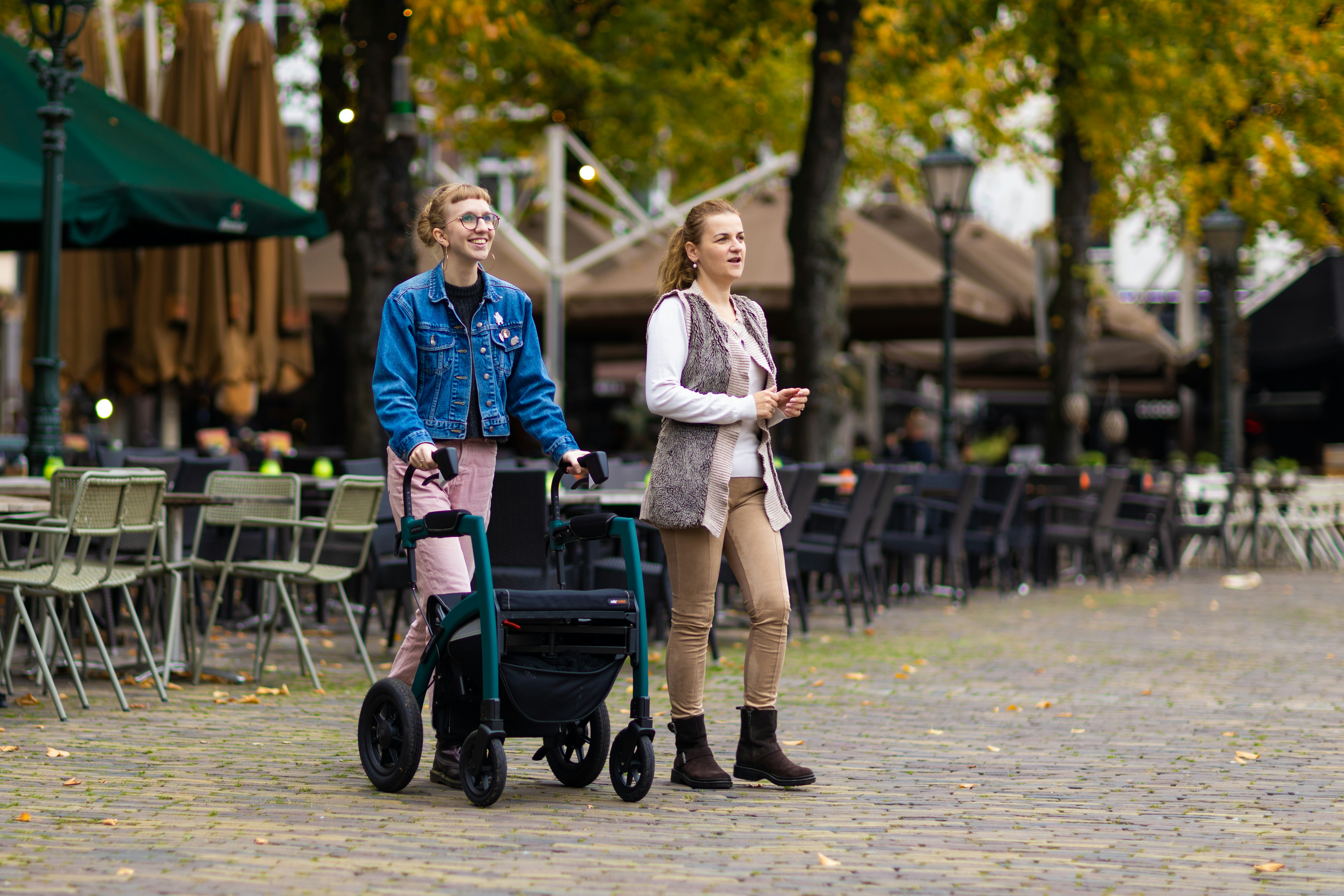 a man and a woman walking with a stroller