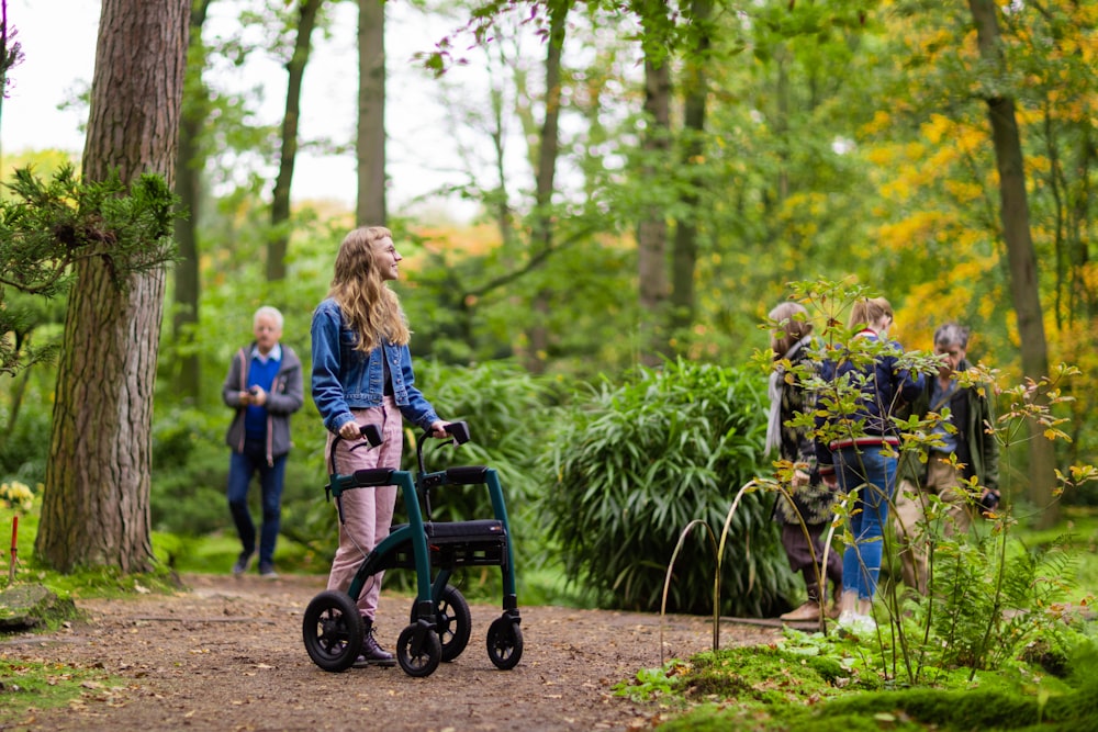 a group of people walking through a forest