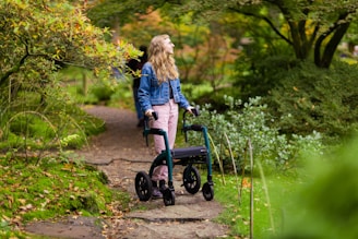 a woman walking with a walker in a park