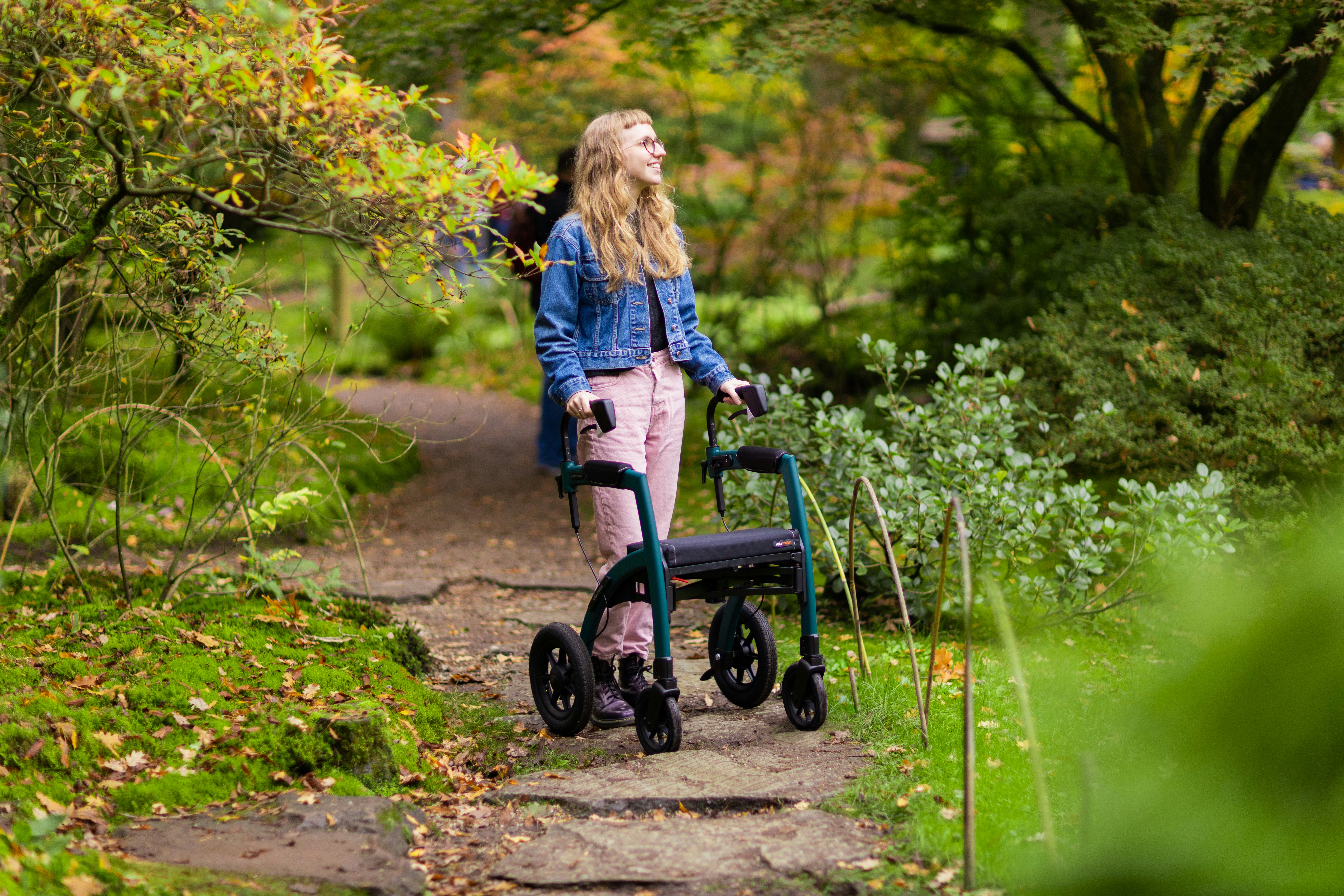 A woman walking with a walker in a park photo – Free Young Image on ...