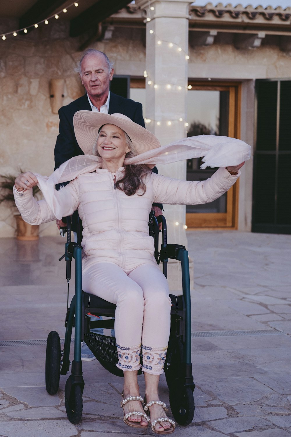 a woman in a wheel chair with a man behind her