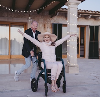 a woman sitting in a wheel chair with her arms outstretched