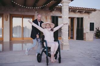 a woman sitting in a wheel chair with her arms outstretched