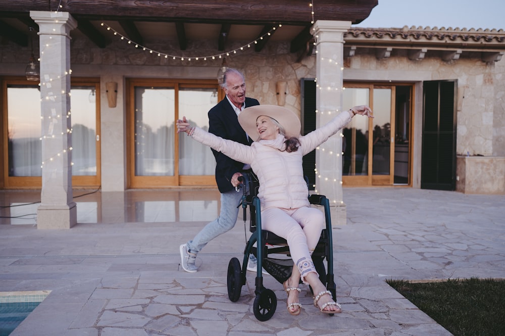 a woman sitting in a wheel chair next to a man