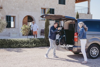 a man standing next to a woman near a car