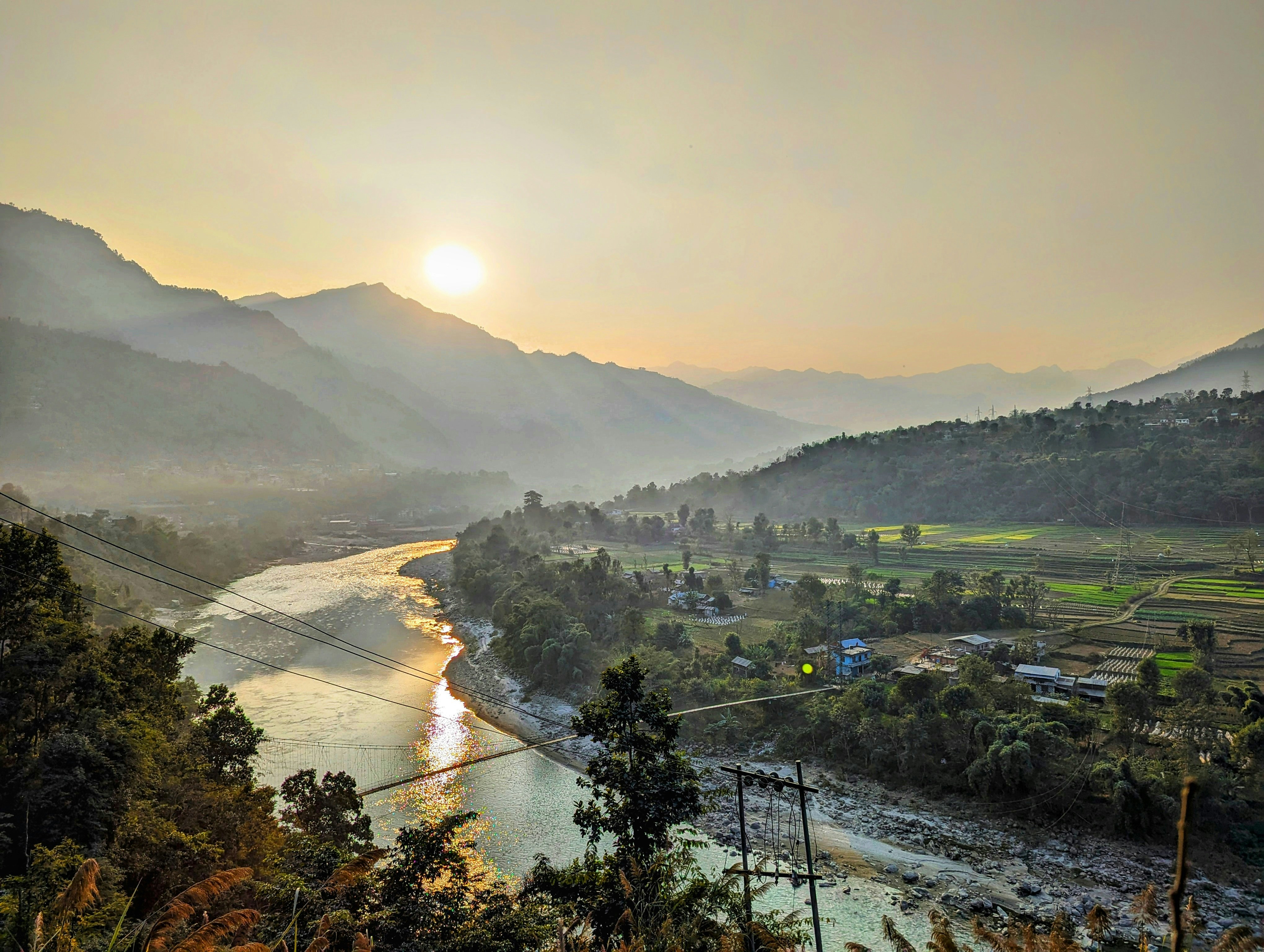 a river running through a lush green valley