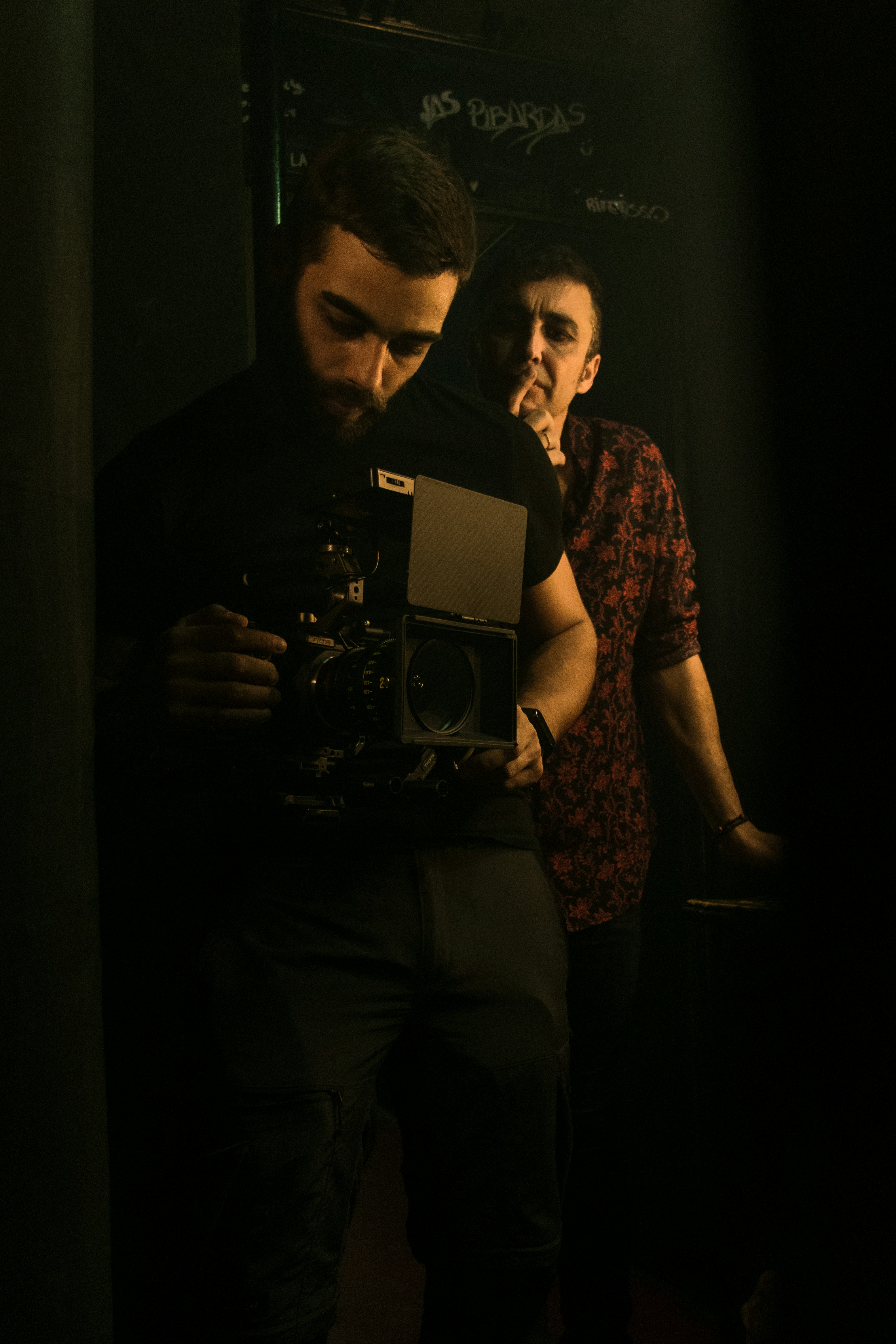 a man standing in front of a mirror holding a camera