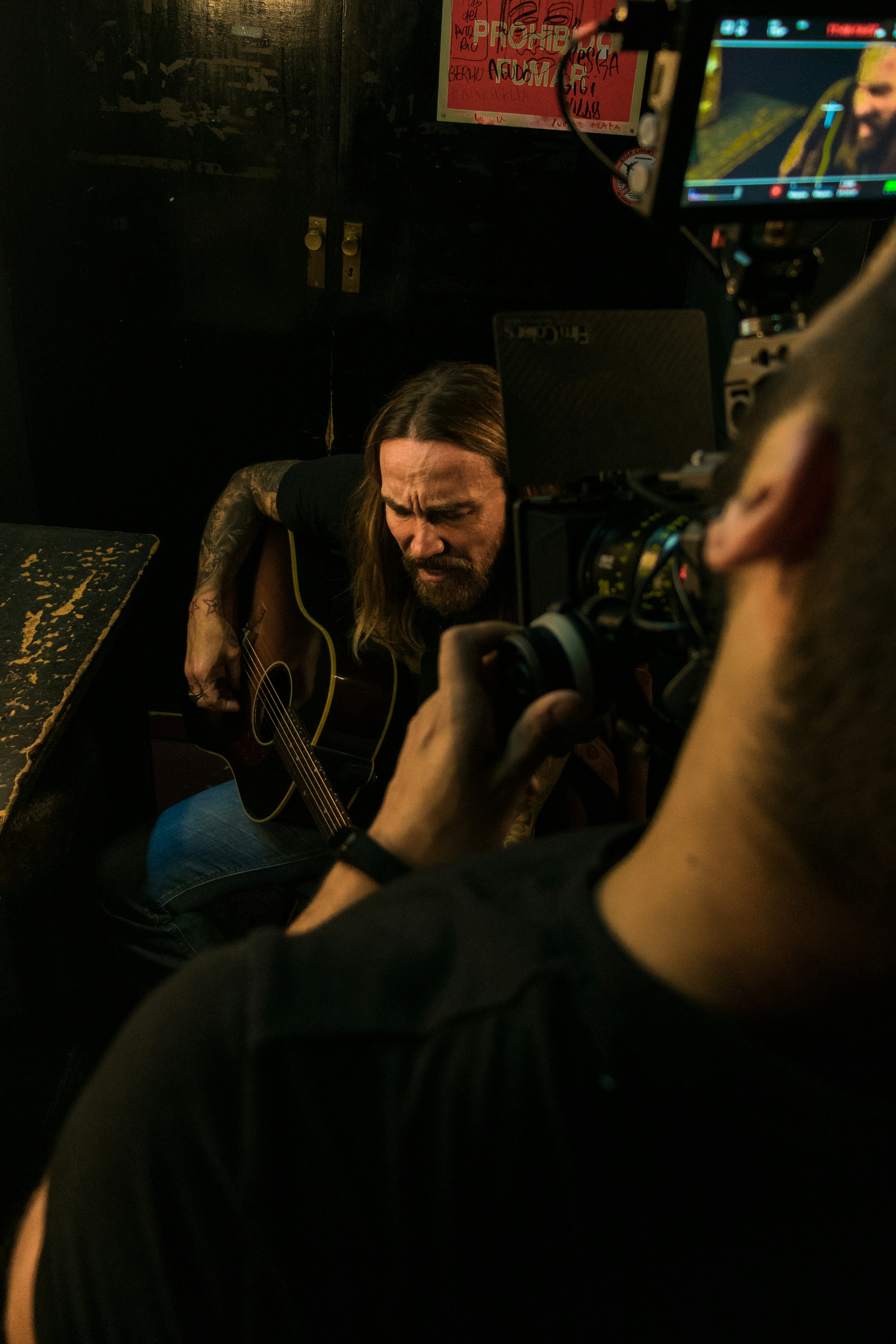 a man with a beard playing a guitar