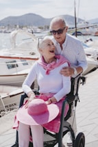 a man and a woman are sitting on a wheel chair