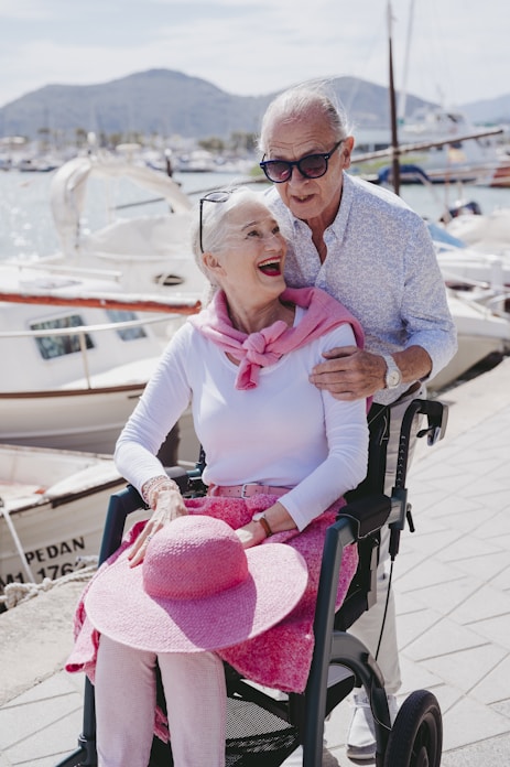 a man and a woman are sitting on a wheel chair