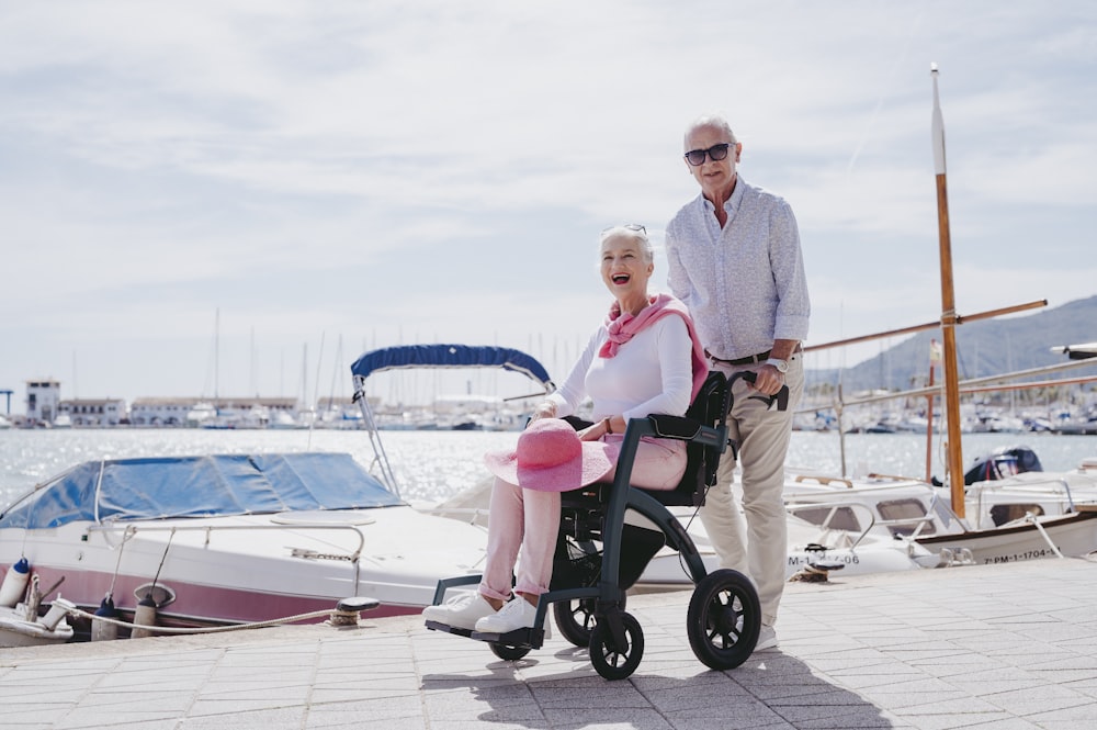 a man and a woman are standing next to a boat