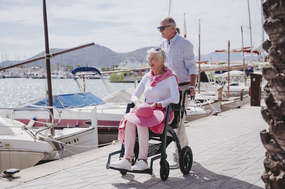 a man and a woman in a wheelchair on a dock