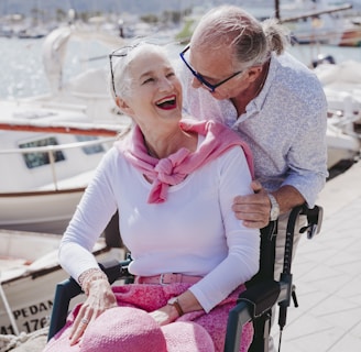 a man and a woman sitting in a wheel chair