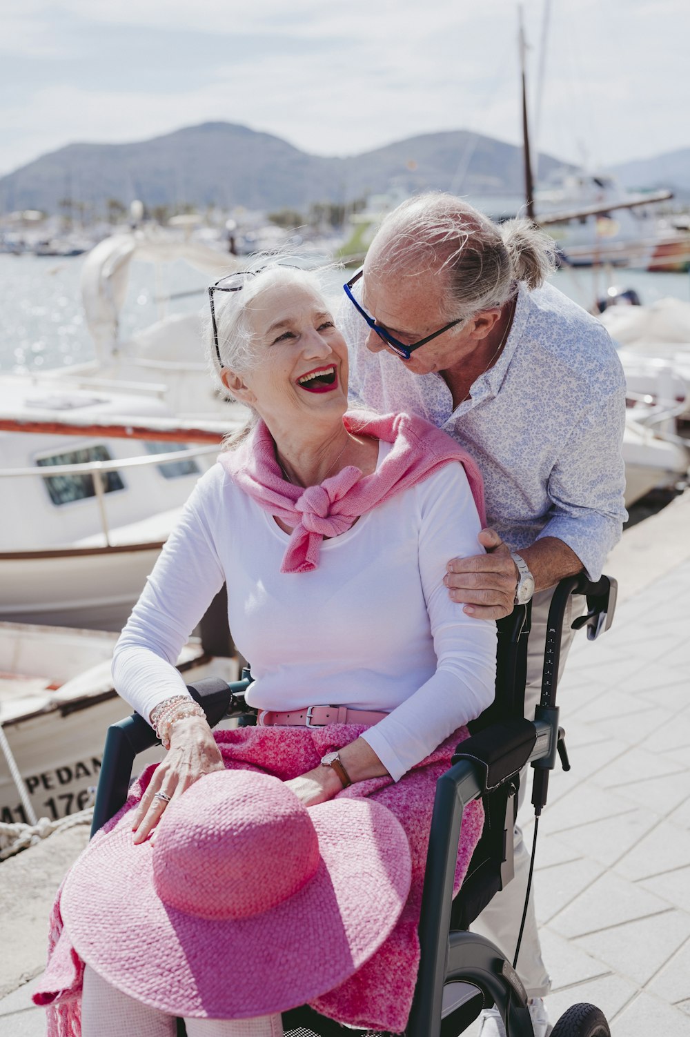 a man and a woman sitting in a wheel chair