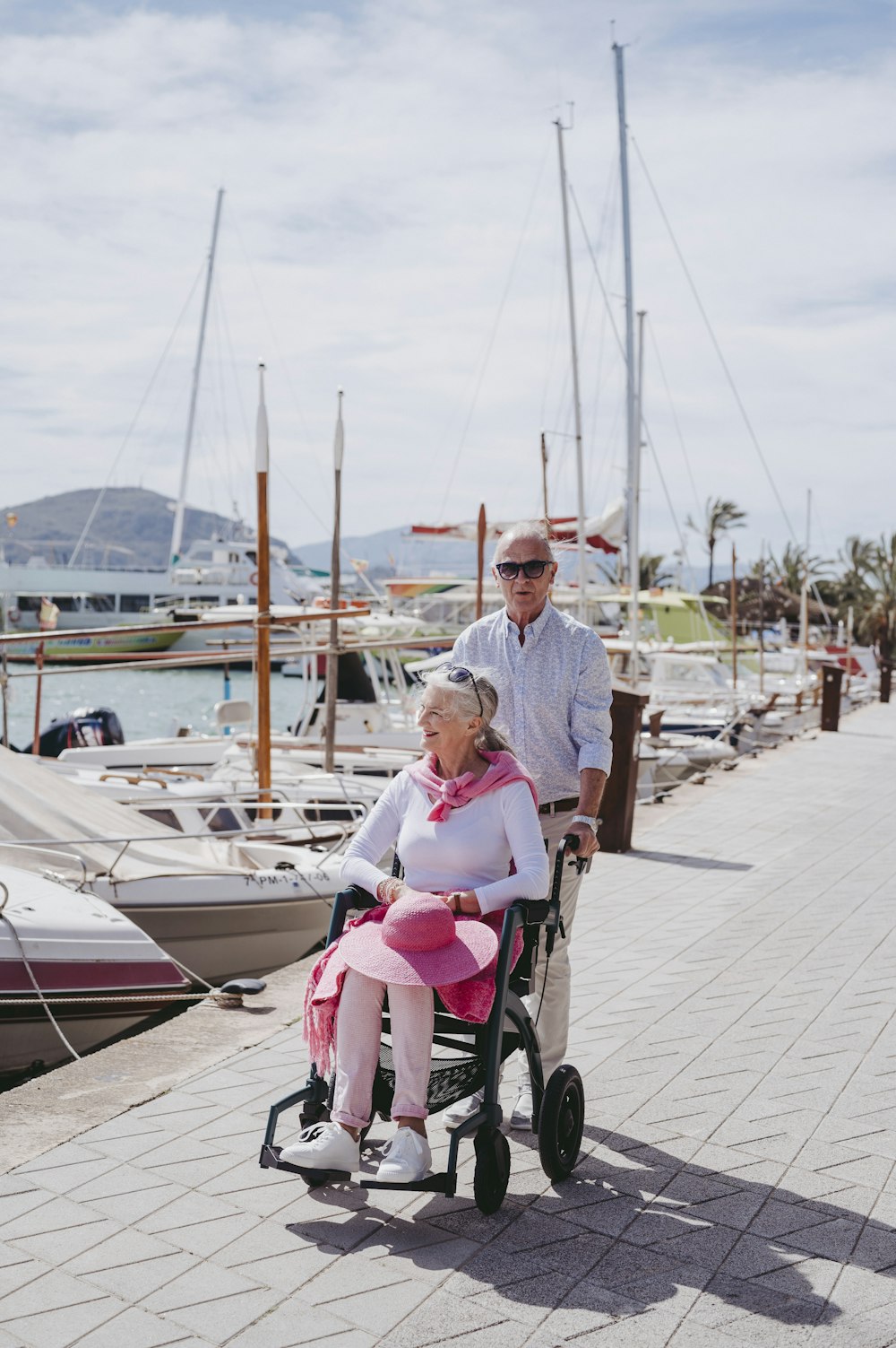 a man pushing a woman in a stroller