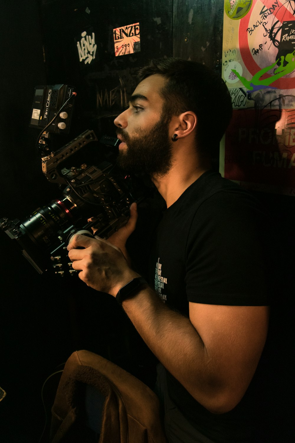 a man with a beard holding a camera