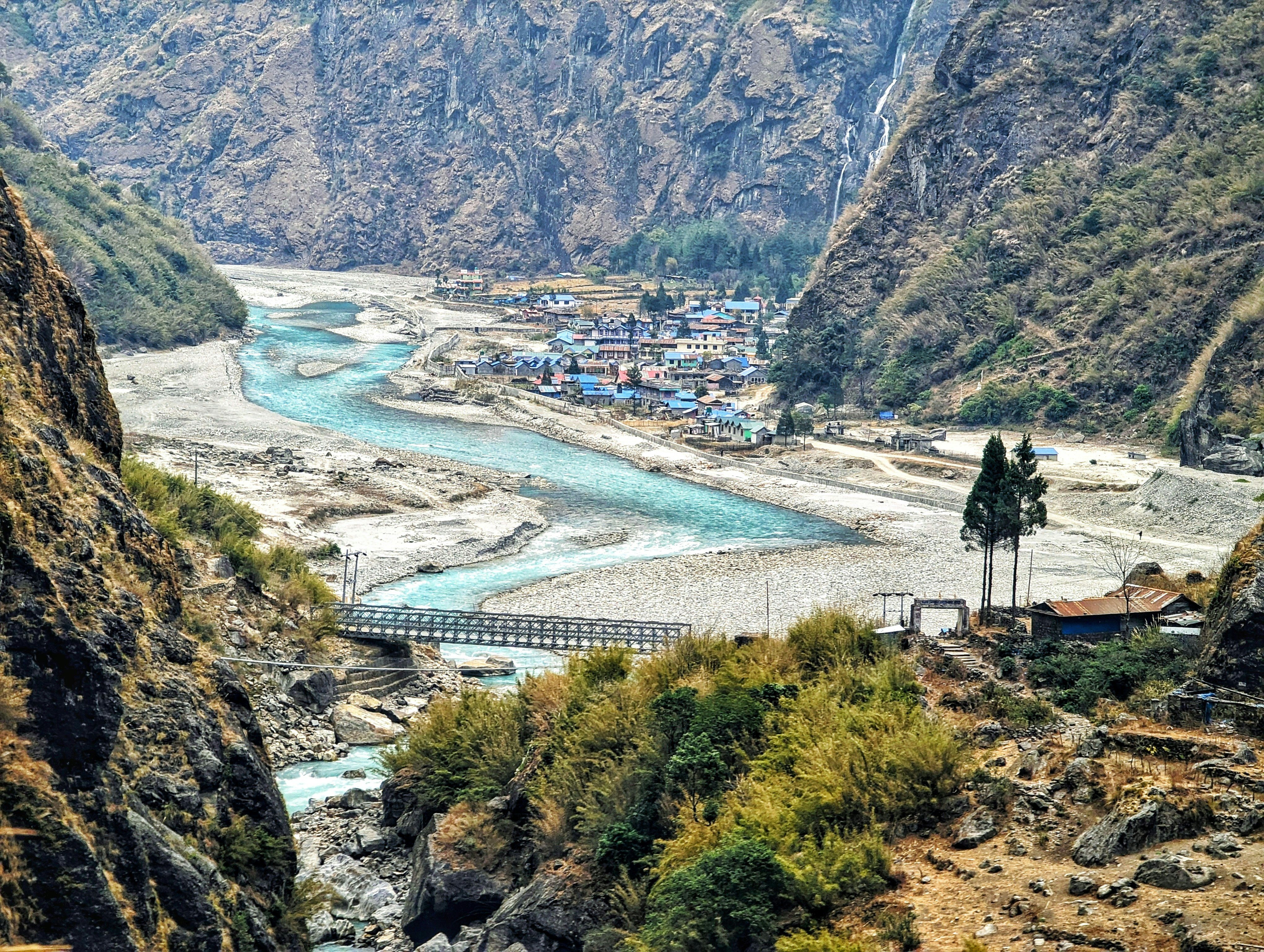 a river running through a valley surrounded by mountains