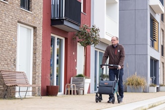 a man pushing a luggage cart down a street