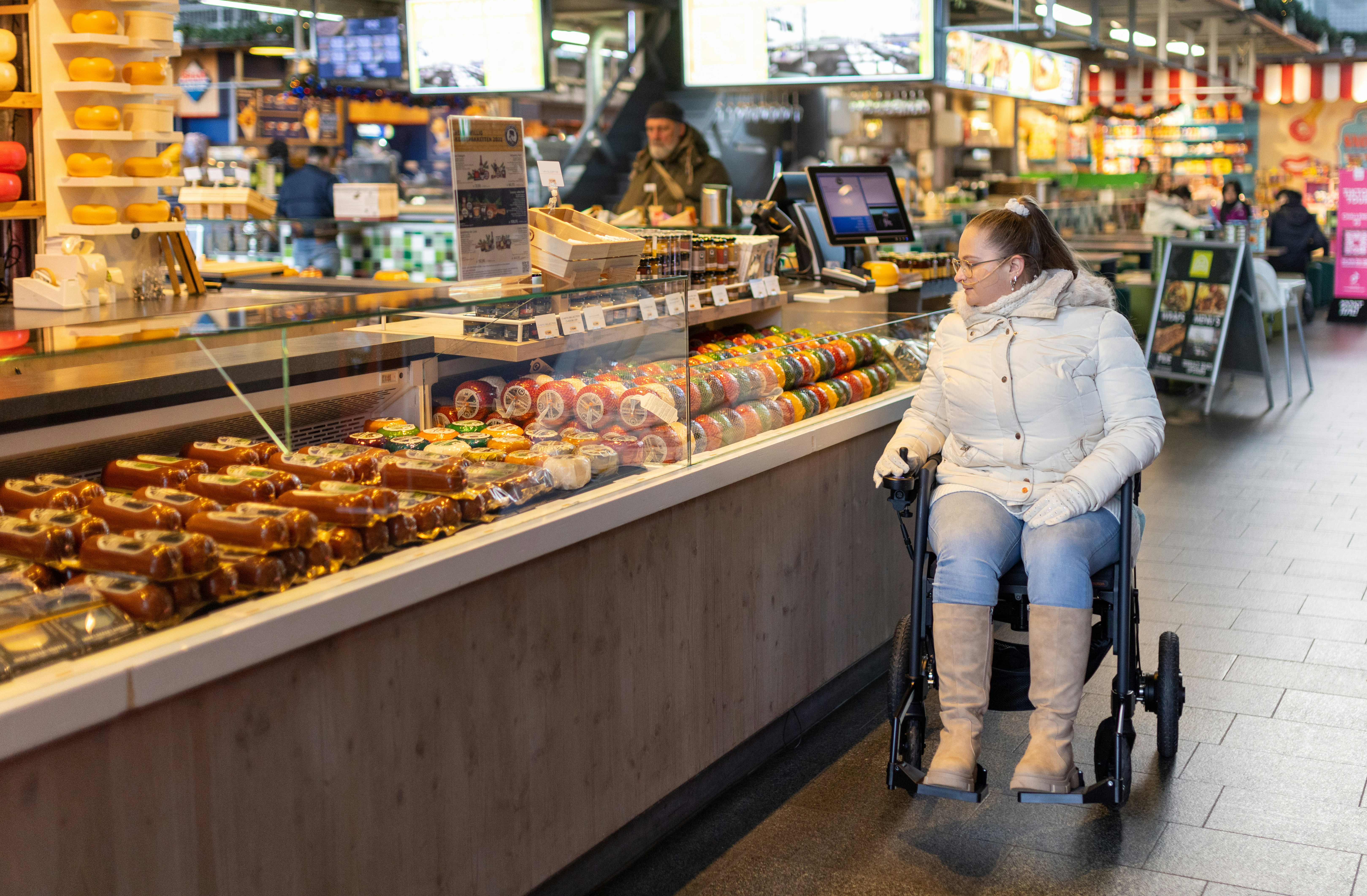 a woman sitting in a wheel chair in a store