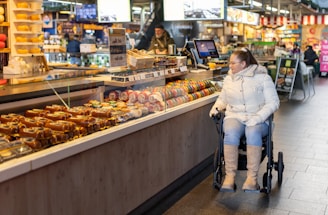 a woman sitting in a wheel chair in a store