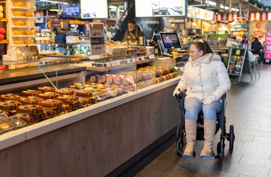 a woman sitting in a wheel chair in a store