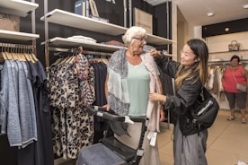 two women are shopping in a clothing store