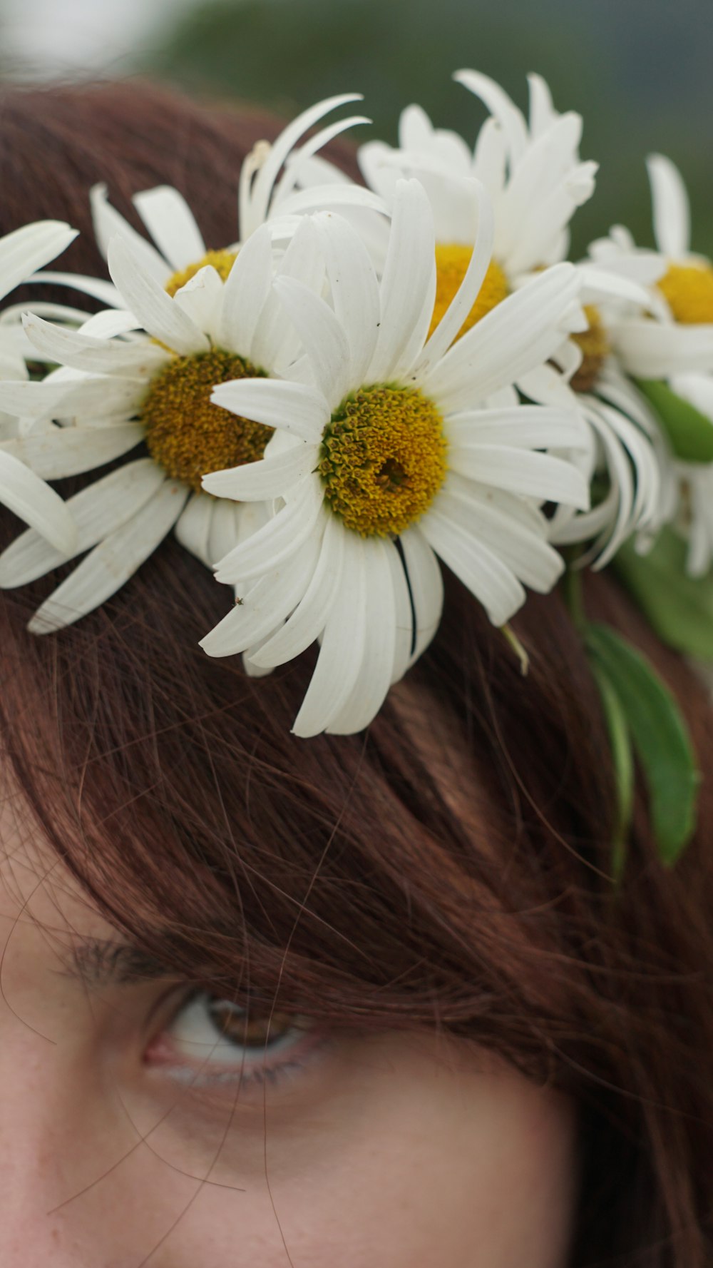 a close up of a woman with a flower in her hair