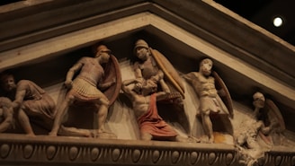 statues of men and women on a wall