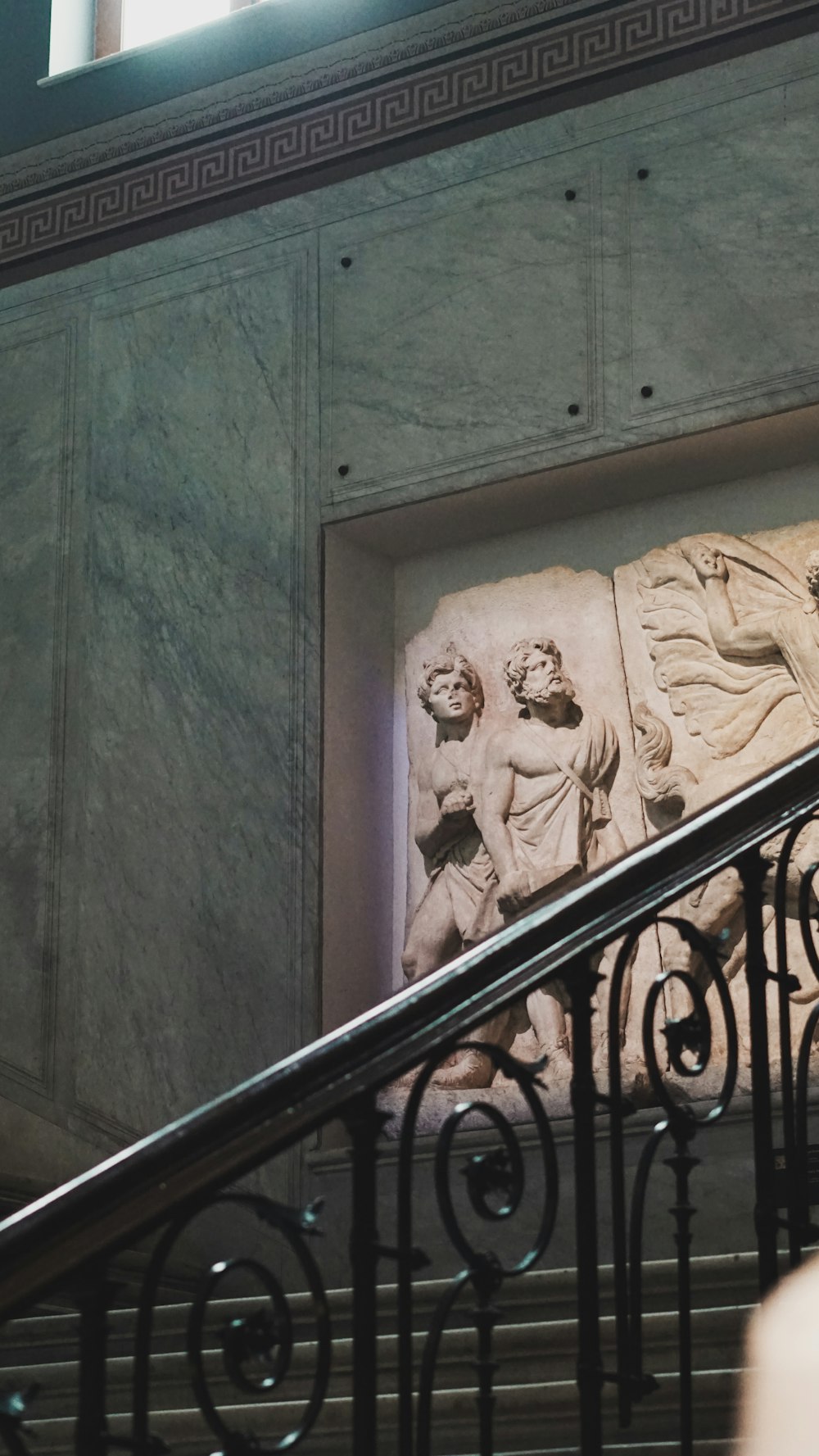 a statue of a man and a woman on a staircase