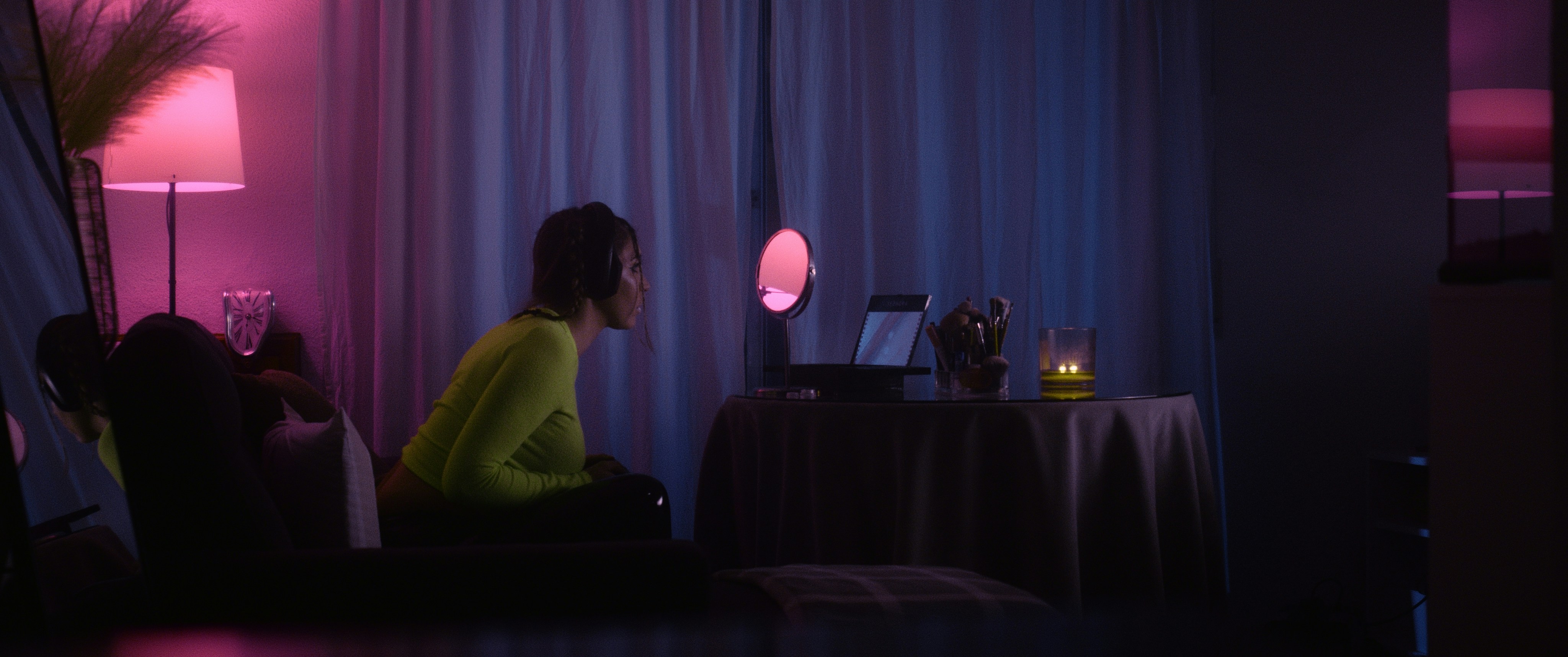 a woman sitting in front of a laptop computer