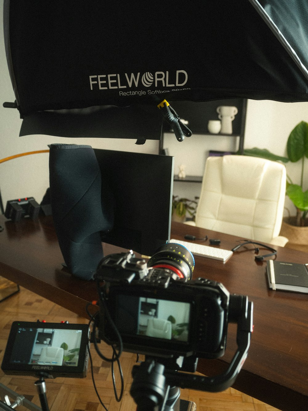 a camera is sitting on a tripod in front of a desk