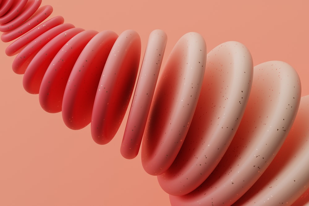 a close up of a pink object on a pink background