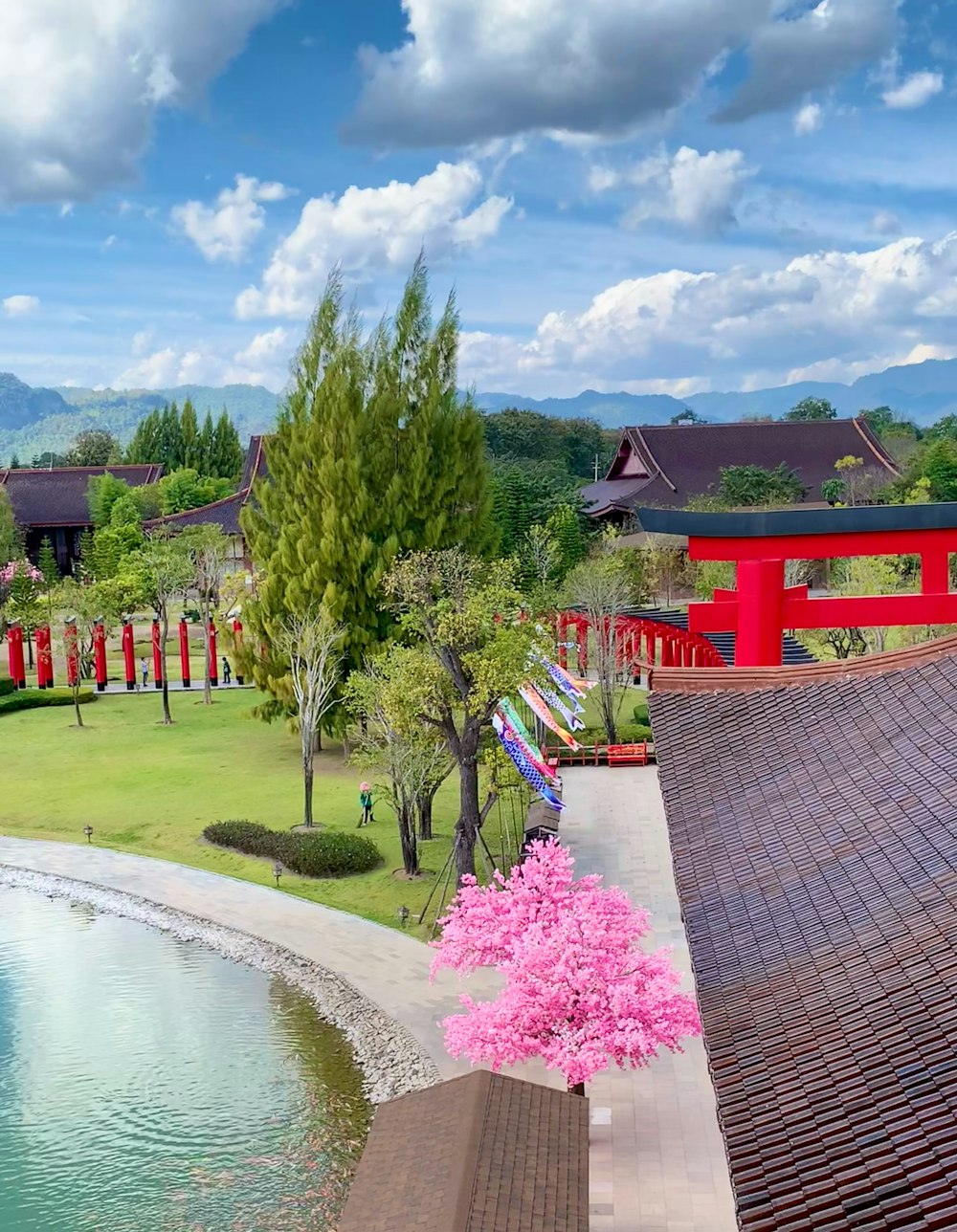 a red building with a pond in front of it