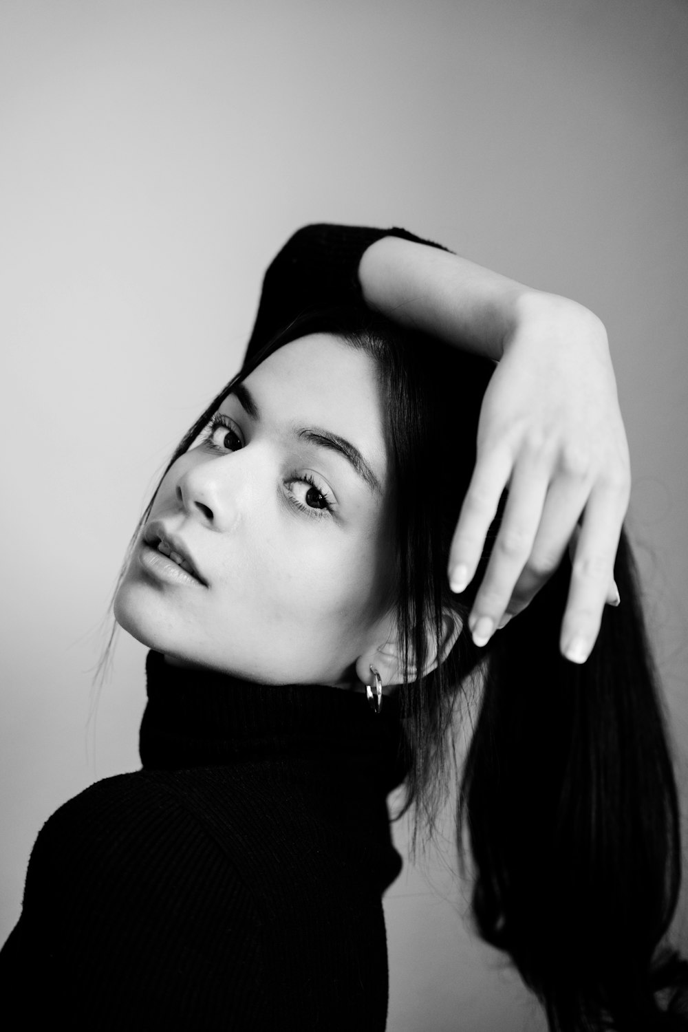 a black and white photo of a woman with long hair