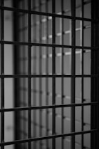 a black and white photo of a jail cell