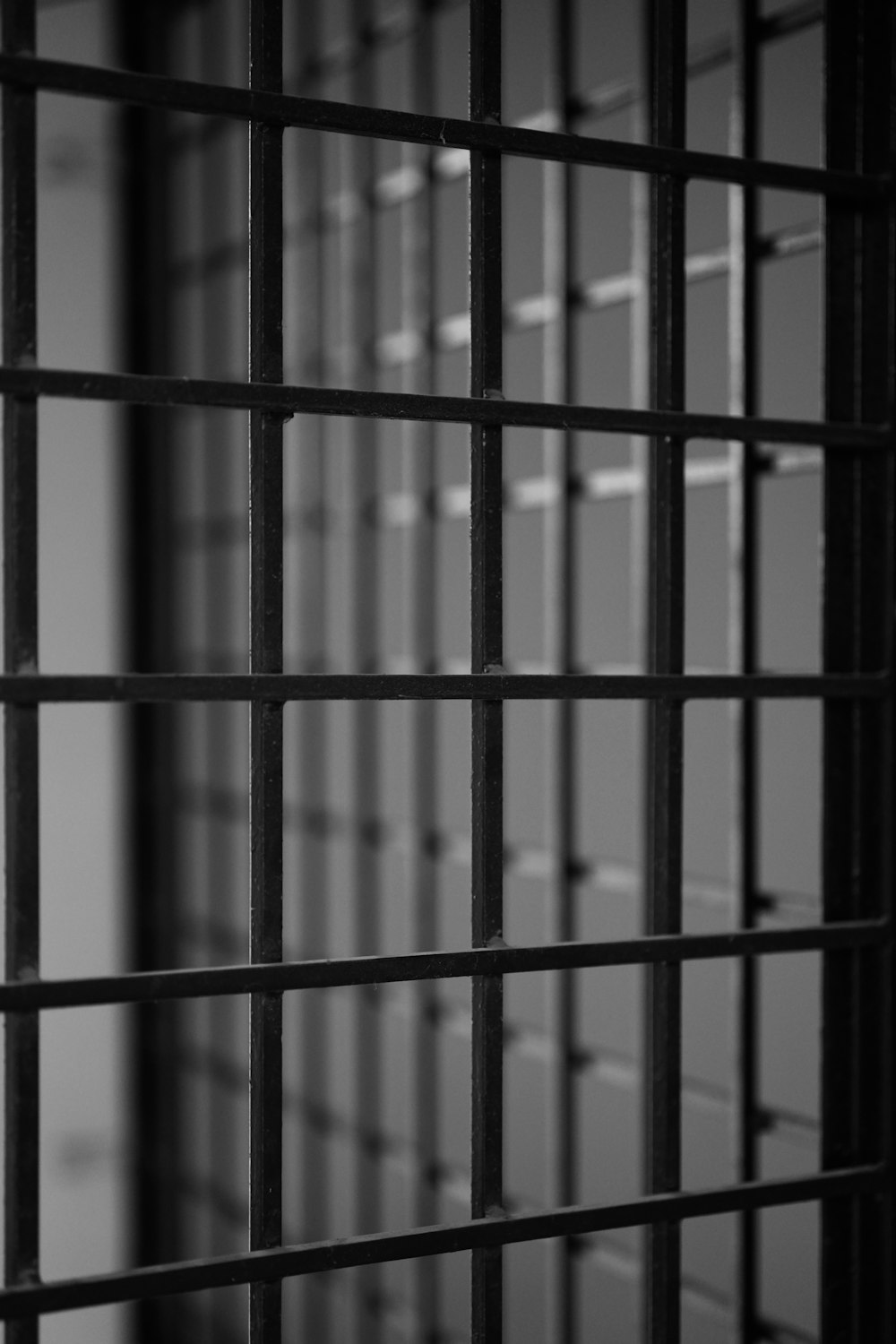 a black and white photo of a jail cell