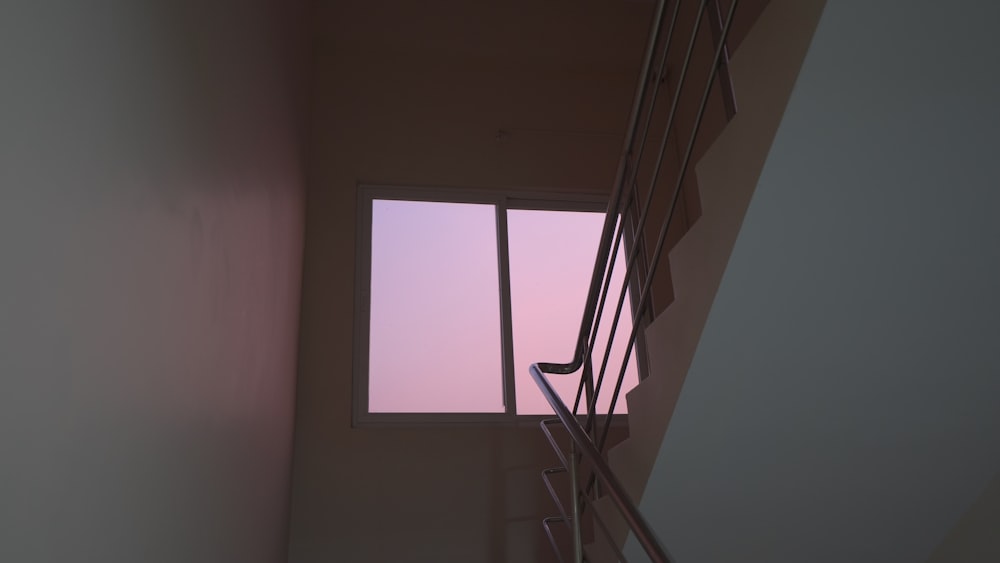 a stair case with a window in the middle of it