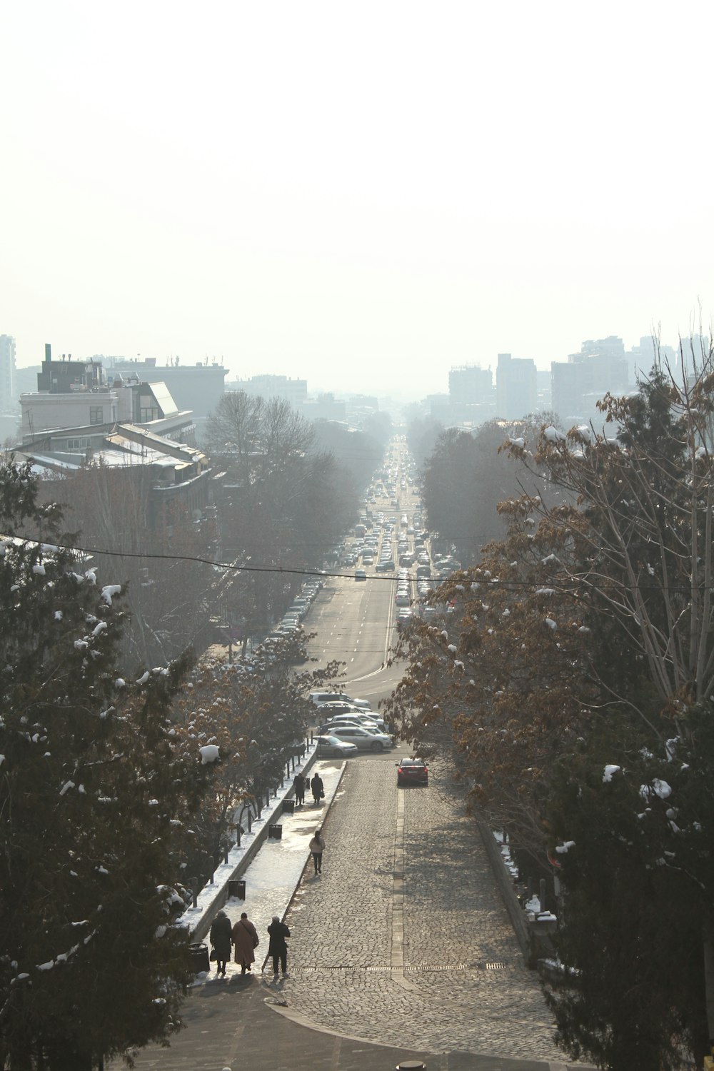 people walking down a street in the snow