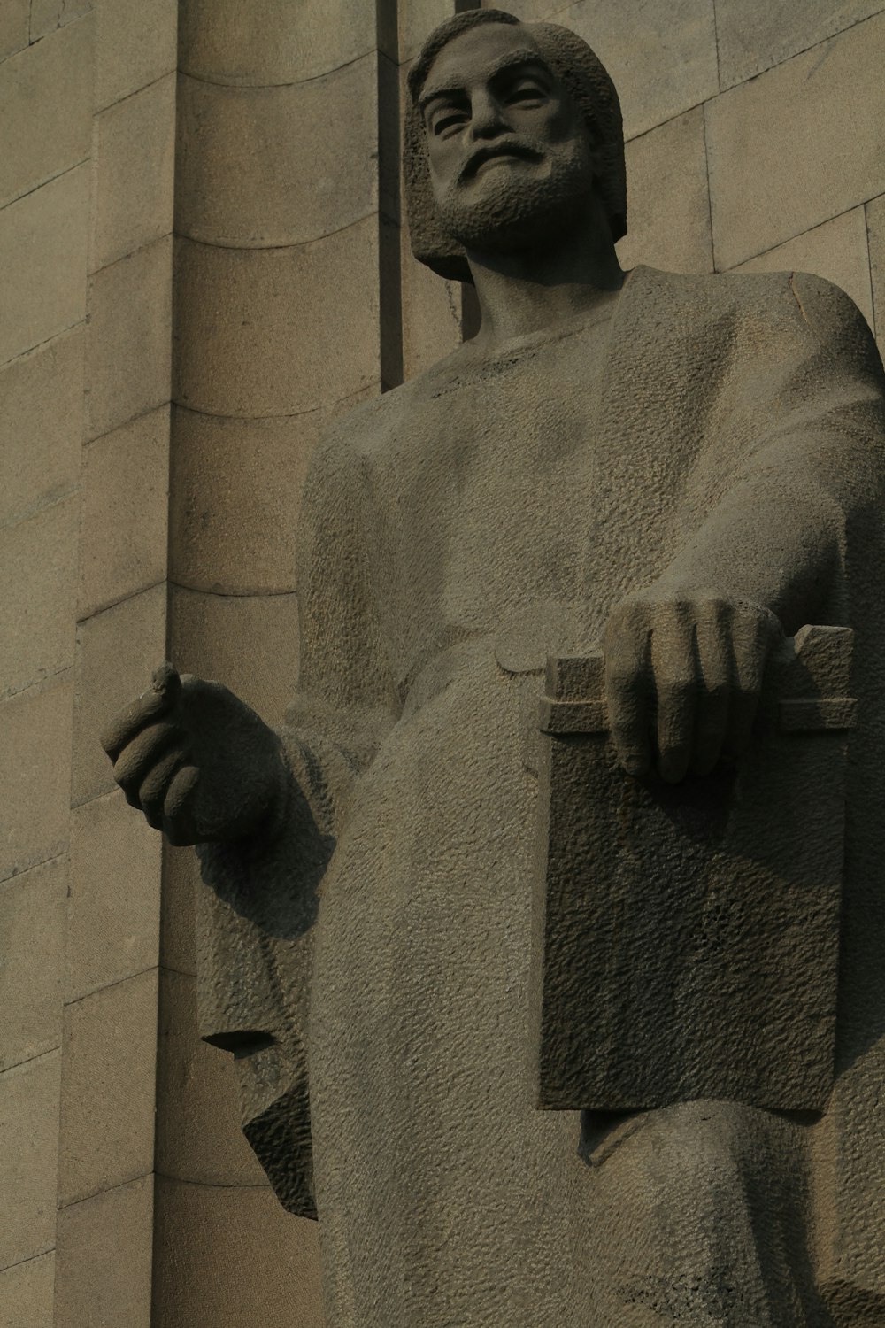 a statue of a man holding a book