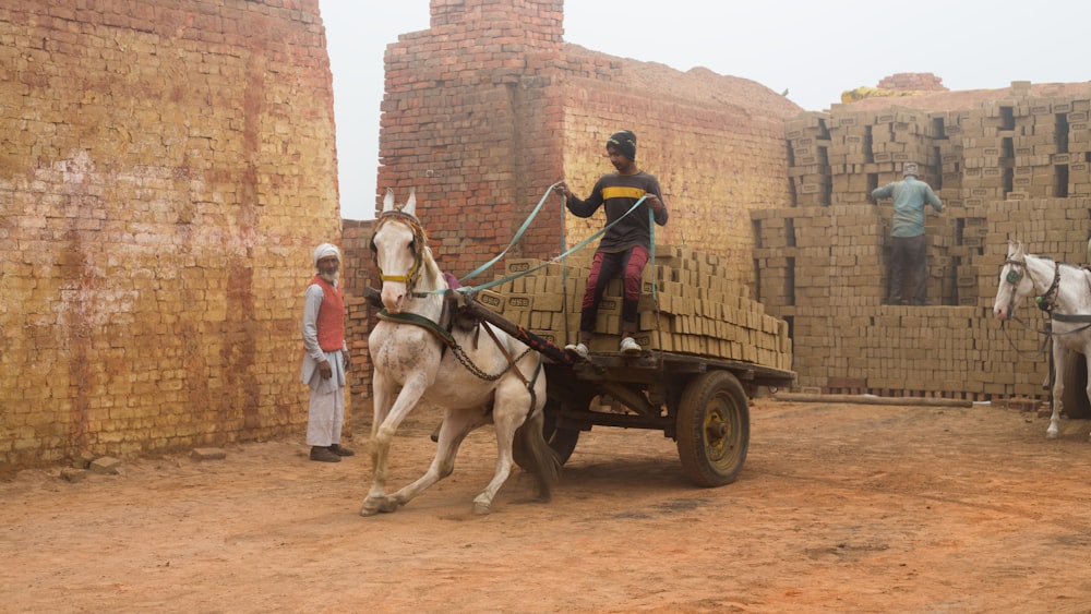 a man riding on the back of a white horse